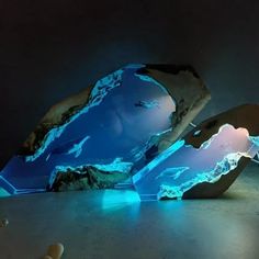 two pieces of art that look like icebergs are glowing in the night sky