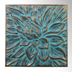 a blue flower is shown in the center of a square metal plaque on a white background