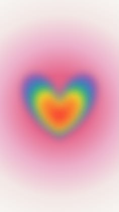 an image of a heart shaped object in the middle of a blurry background with colors