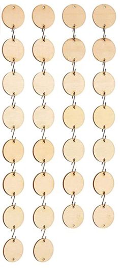 several wooden circles hanging from a metal hook on a white background with clippings