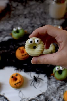 a person is holding some food in front of them with googly eyes on it