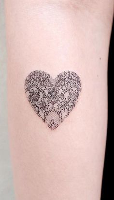 a heart shaped tattoo on the arm