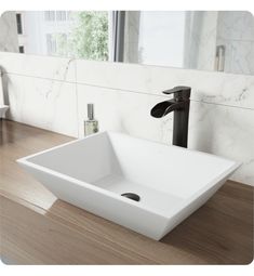 a white square sink sitting on top of a wooden counter next to a bathroom mirror