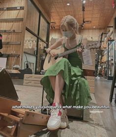 a woman sitting on top of a chair with a guitar in her hand and a quote about what makes you unique is what make you beautiful