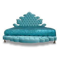 a bed with blue sequins on the headboard and foot board, sitting in front of a white background