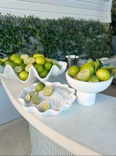 limes and other fruit are on display in bowls