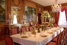 a fancy dining room set up for a formal dinner