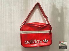 An original vintage Adidas sport bag from the 1980's. An absolute gem for vintage fans. Size:  40 x 30 x15 H x W x D (all dimensions are in cm) Materials: artificial leather, textile, metal condition: The bag is in excellent vintage condition, depending on its age.  The zippers work perfectly. Signs of use. See pictures for details. Shipping: - My shop ships worldwide. - If you like, select the "EXPRESS  shipping" option in the order process to get faster shipping. - You can see the shipping prices in the Shipping menu. Choose your country and your shipping price will appear. - If you order multiple items, the shipping price is automatically calculated as a collective order. So you always get the lowest shipping price. - After the payment the articles are ready for dispatch after 1-2 days. Red Rectangular Sports Bag, Vintage Red Shoulder Bag For Daily Use, Vintage Red Rectangular Shoulder Bag, Vintage Red Bags For Daily Use, Sporty Red Rectangular Bag, Retro Red Travel Bags, Vintage Red Shoulder Bag For Travel, Retro Red School Shoulder Bag, Vintage Red Shoulder Bag