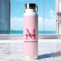 a pink water bottle with the word morgan on it