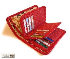 an open wallet with pens and pencils in it