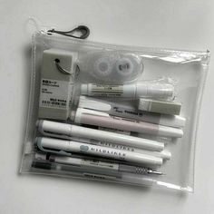 a clear bag filled with lots of different types of pens