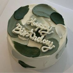 a birthday cake with green and white frosting