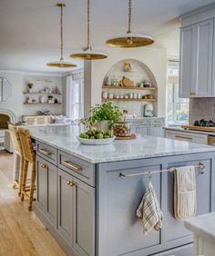 a large kitchen with an island in the middle and lots of counter space around it