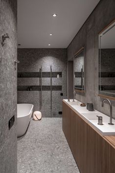 a large bathroom with two sinks and a bathtub in the middle, along with a walk - in shower