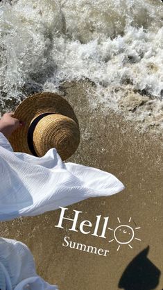 a woman in white dress and straw hat standing on beach next to ocean waves with hello summer logo