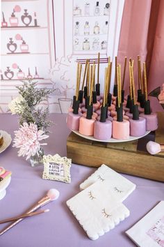 a table topped with lots of pink and gold items