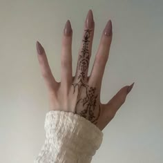 a woman's hand with tattoos on it