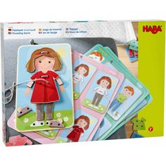 a set of children's magnets featuring a girl in a red dress