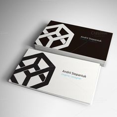 two black and white business cards on top of each other, one with an abstract design