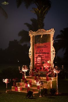 an elaborately decorated display with candles in the shape of hearts and flowers on steps