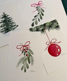 four christmas cards with red and green ornaments