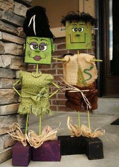 three paper bag puppets sitting on top of each other in front of a brick wall