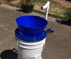 a blue and white bucket sitting on top of a street