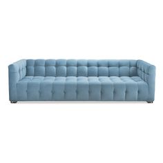 a blue couch sitting on top of a white floor