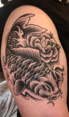 a black and white image of a fish with flowers on it's back shoulder