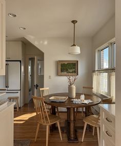 a dining room table with four chairs around it