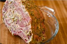 a meatloaf in a glass bowl on a wooden table