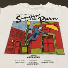 a white t - shirt with the title singin'in the rain on it