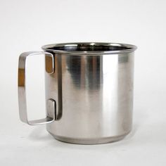 a stainless steel mug with a wooden handle on a white background, showing the inside