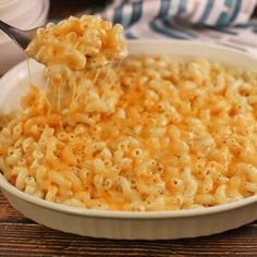 macaroni and cheese being scooped from a dish