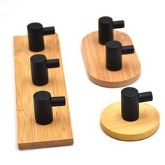 three wooden pegs with black knobs on them