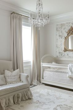 a baby's room with a crib, bed and chandelier in it