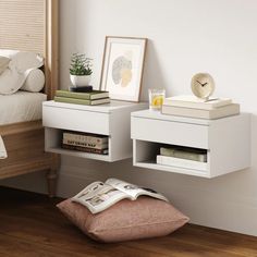 two white nightstands sitting next to each other on top of a wooden floor