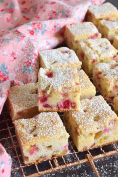 three ingredient rhubarb squares are stacked on a cooling rack with powdered sugar