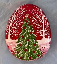 a painted rock with a christmas tree on it