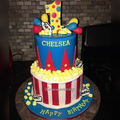 a birthday cake made to look like a clown's hat with popcorn on top