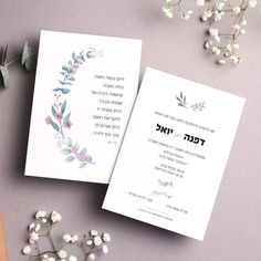 two cards with floral designs on them next to some flowers