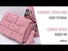 a pink crochet purse sitting on top of a table