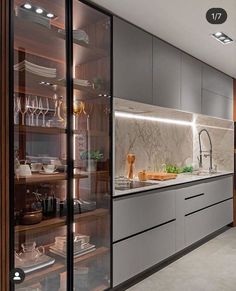 a modern kitchen with stainless steel appliances and marble counter tops