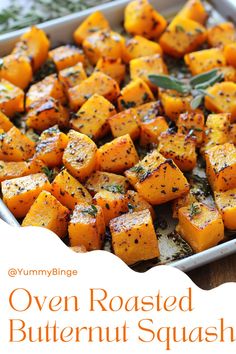 roasted butternut squash in a baking dish with herbs and seasoning on the side