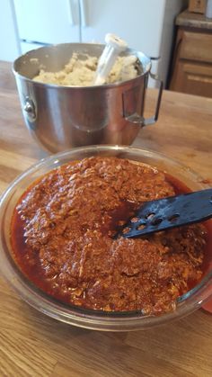 a person is using a spatula to stir up food in a bowl on a table