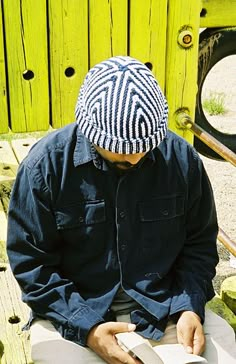 a man sitting on a bench reading a book