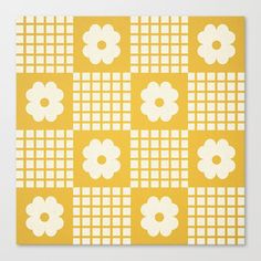 a yellow and white pattern with flowers on the squares canvas print by artbyte