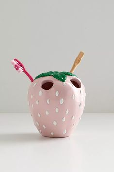 a toothbrush holder shaped like a strawberry