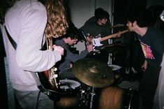 a group of people playing instruments in a room