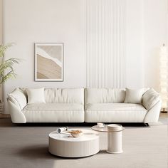 a living room with white furniture and a large painting on the wall over the couch